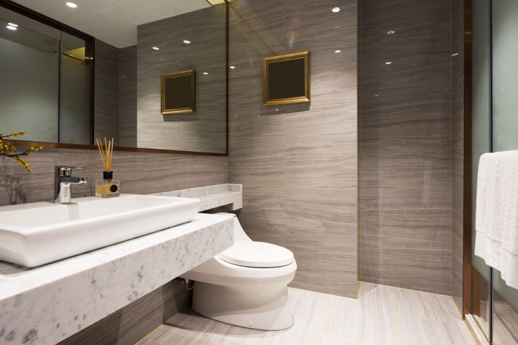 Bright layered lighting setup in a contemporary residential bathroom, showcasing professional lighting installation services by Dustmen Electric.