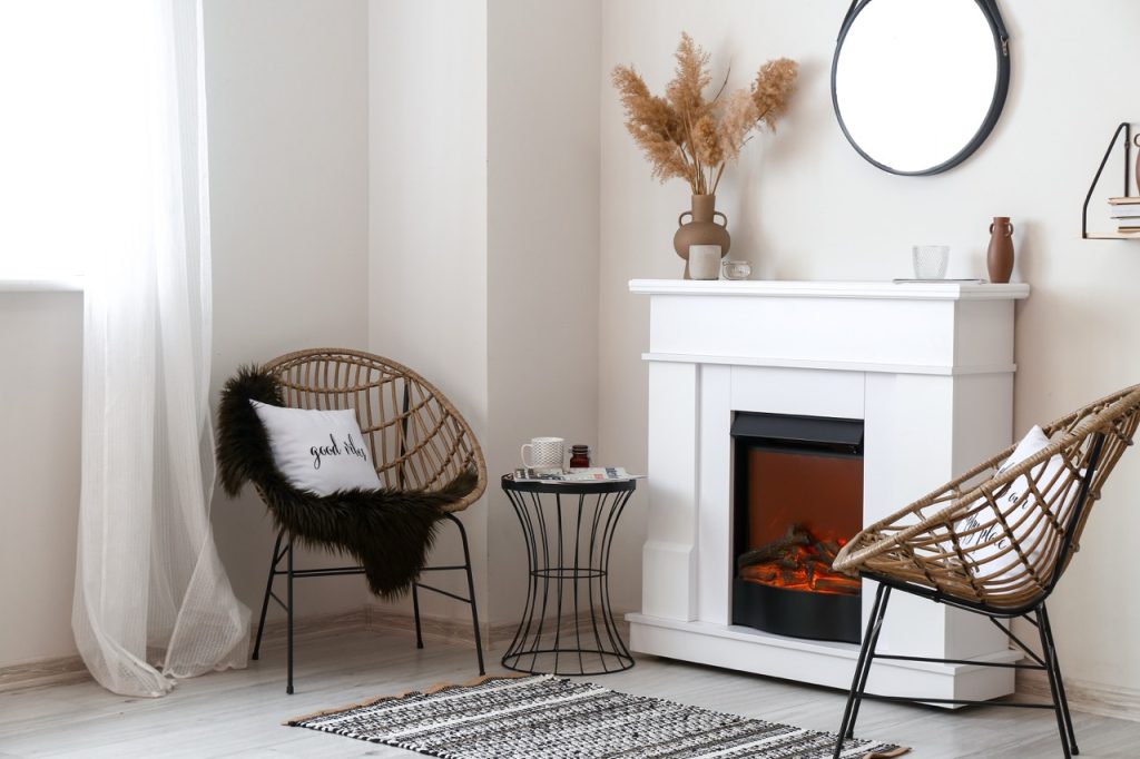 An electric fireplace insert warming a home, highlighting essential fireplace heater safety tips provided by Dustmen Electric.