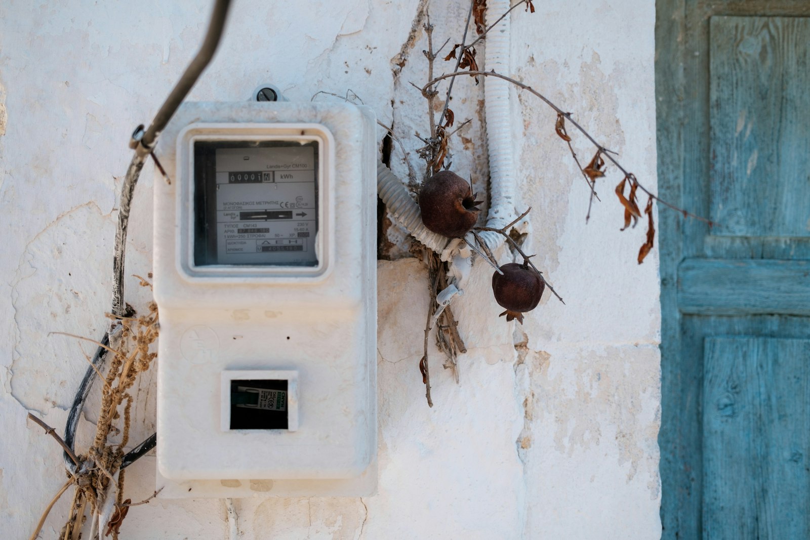 Older electrical meter mounted on the exterior of a home